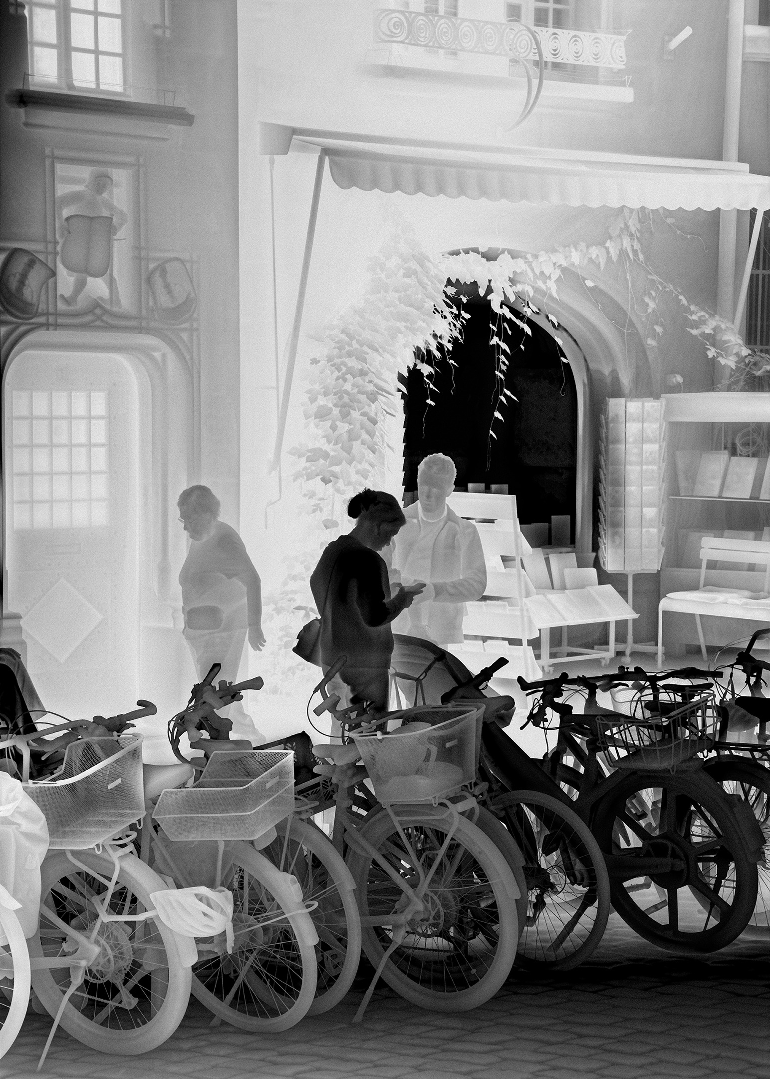 Une vathographie&nbsp;: des vélos garés devant une boutique dans une vieille rue, pâles au premier plan.