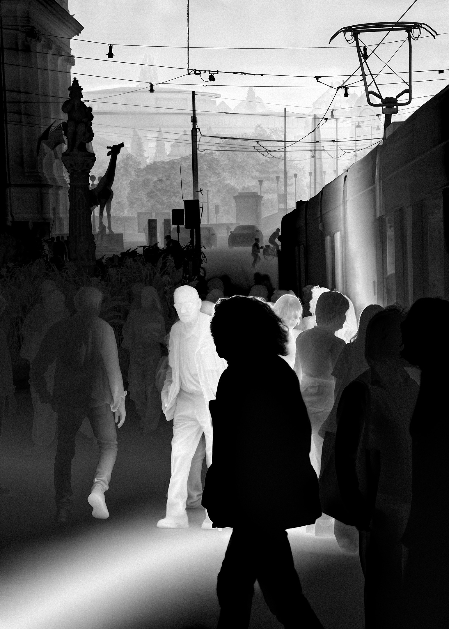 Une vathographie&nbsp;: une foule sur un quai de tram, un homme en blanc parmi des silhouettes sombres, le lointain s’effaçant vers le blanc.